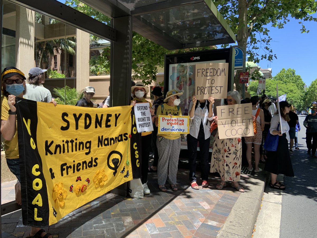 knitnannasSYD's tweet photo. Huge loud protest outside NSW Parl today, in support of Violet Coco. Perrottet says it’s ‘pleasing to see’ her harsh sentence of 15 months jail for blocking 1 lane of Harbour Bridge for 25 mins to draw attention to our looming climate catastrophe. https://t.co/dEokXQMwLR