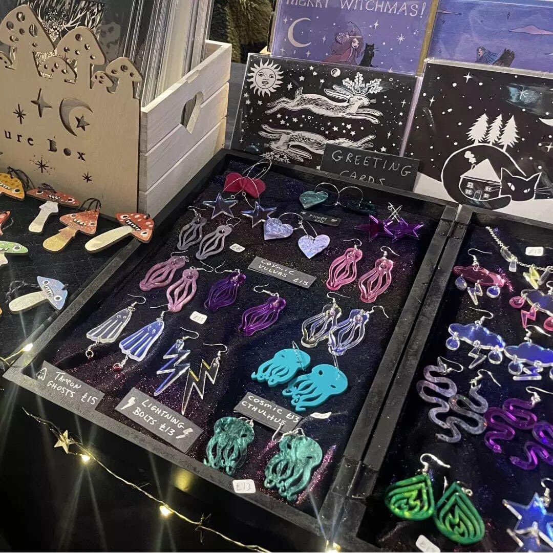 A purveyor of midnighty loveliness, a curiosity cabinet of handmade trinkets, art and adornments. From lasercut jewellery to giclée prints, cards, zines, mugs and coasters.