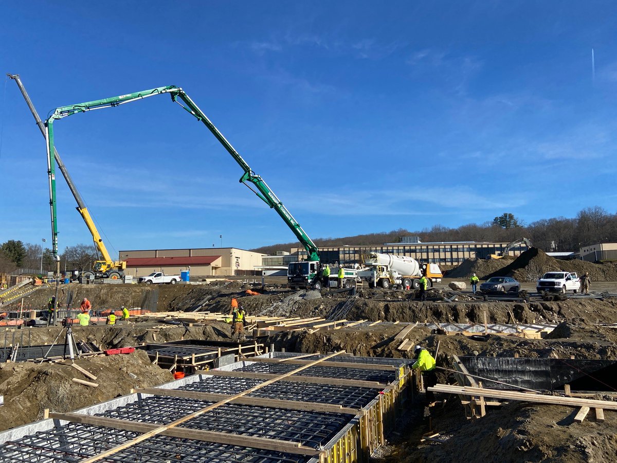 Concrete Pozzotive, High-Quality Ground Glass Pozzolan, being poured at our Torrington High School Project. Over 12,000 pounds of cement was replaced in this 100-yard pour keeping over 24,000 glass containers out of the landfill! #sustainability #sustainableconcrete #recycling