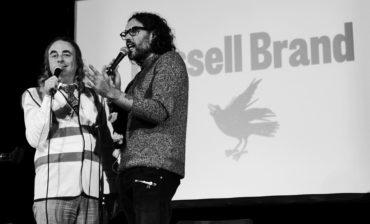 thenewathens's tweet photo. #Mummery between Russell Brand @rustyrockets and @paulfoot allegorising the Sun, which casts its illuminating Rays (value £1.5bn) on the financial Shenanigans of us all, in our impartial Considerations of all the legitimate and viable bids for #CommunityTrustAssets.

#SellBrand https://t.co/qRfnvvw1IY