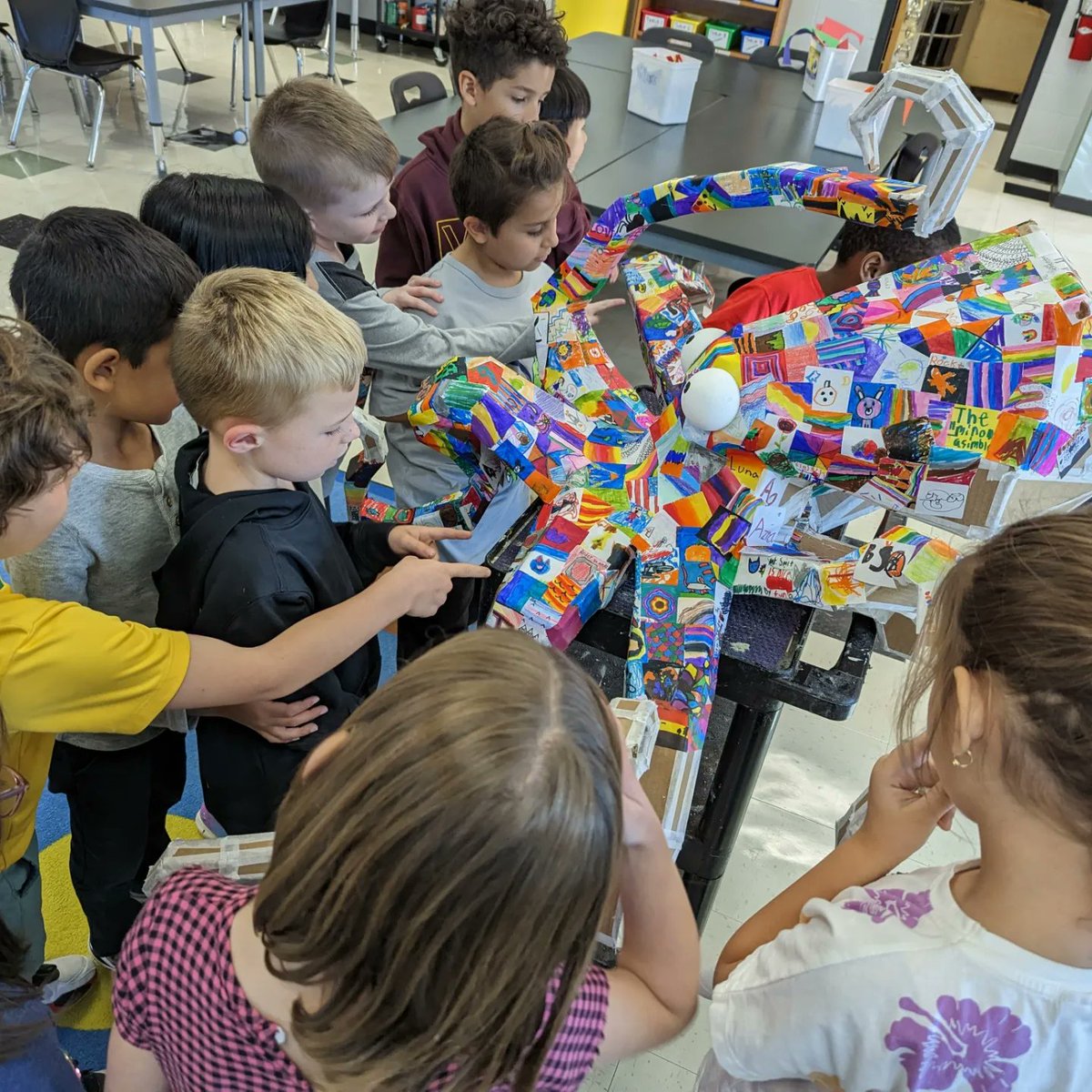 I spent the first quarter of the year building an octopus sculpture out of cardboard.  The last step was having the k-4th graders and any willing staff in the building color stickers to give it a unique skin.  Now it hangs in the back of the room keeping an eye on the art room