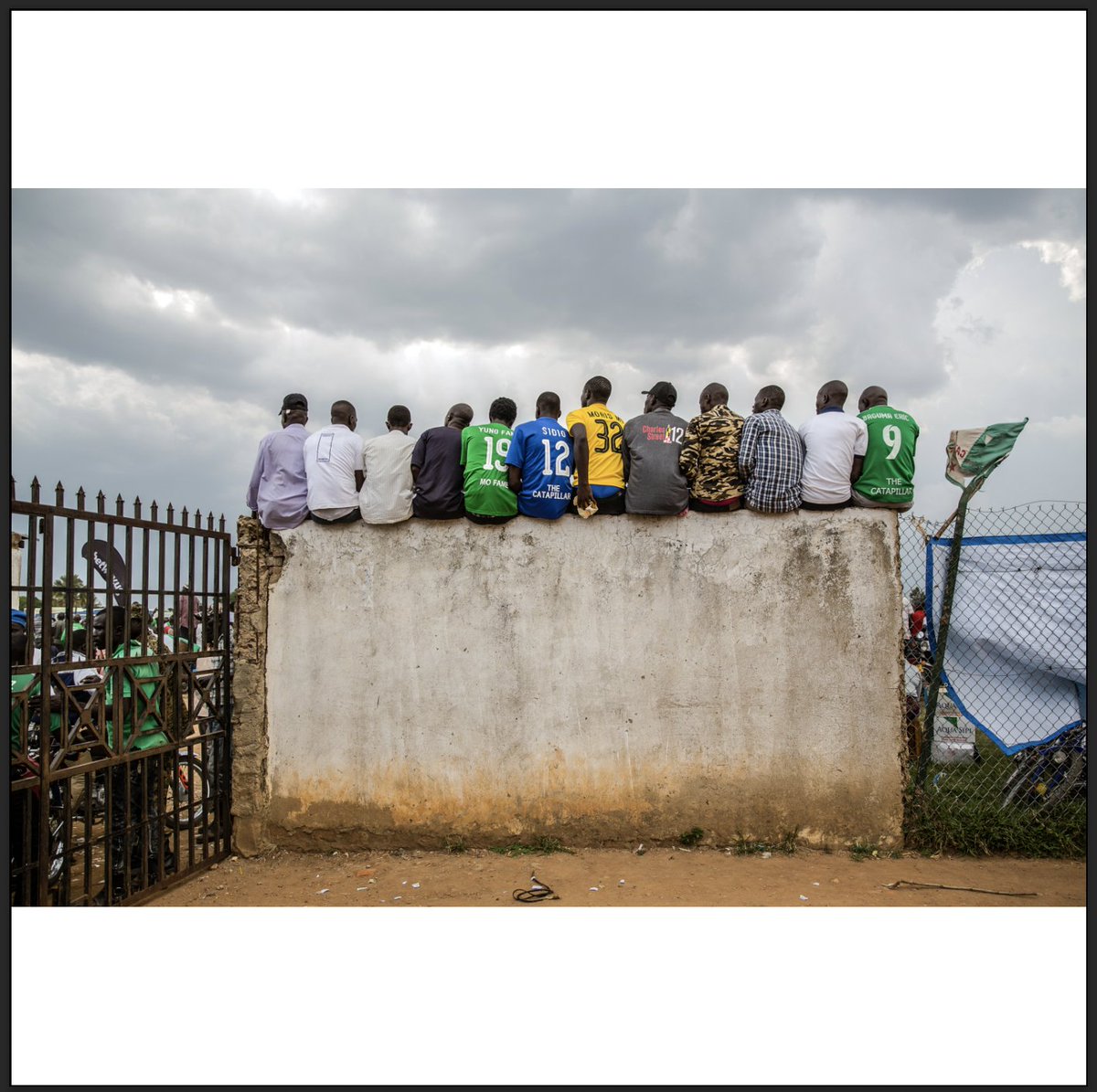 'Onduparaka Football club fans sit on a fence to get a better view of the match during a Uganda Premier League tournament.' 📸 by @EstherR_Mbabazi 

Buy this print here as part of Light of Day: A Print Sale by The Everyday Projects: everydayprojects.org/print-sale/est…
