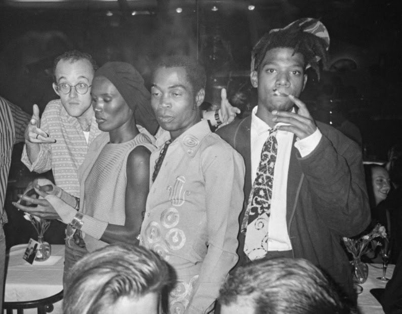 60sto70sto80s's tweet photo. Midtown Manhattan, NYC (1986). Keith Haring, Grace Jones, Fela Kuti, and Jean-Michel Basquiat enjoy their time at Mr. Chow restaurant on 57th Street. Photographed by Andy Warhol. https://t.co/CbMuBEa7a8