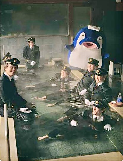 mondomascots's tweet image. Kotochan the dolphin, mascot of the Kotoden-Kotohira train line, goes to the bathhouse with his train conductor friends.