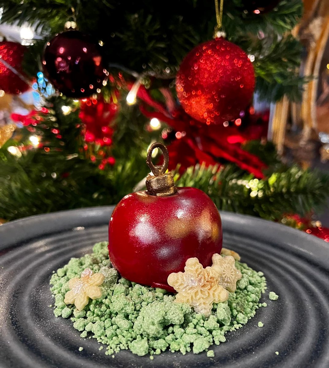 Our edible bauble is back! 
A set vanilla custard, candy red mirror glaze &amp; apple compote center.