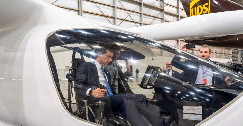UPSPolicy's tweet photo. During his visit to UPS Worldport, @USDOT's @SecretaryPete learned about UPS's innovative sustainability strategies including the all-electric ALIA aircraft from BETA. Technology innovations advance our goal of being carbon neutral by 2050.