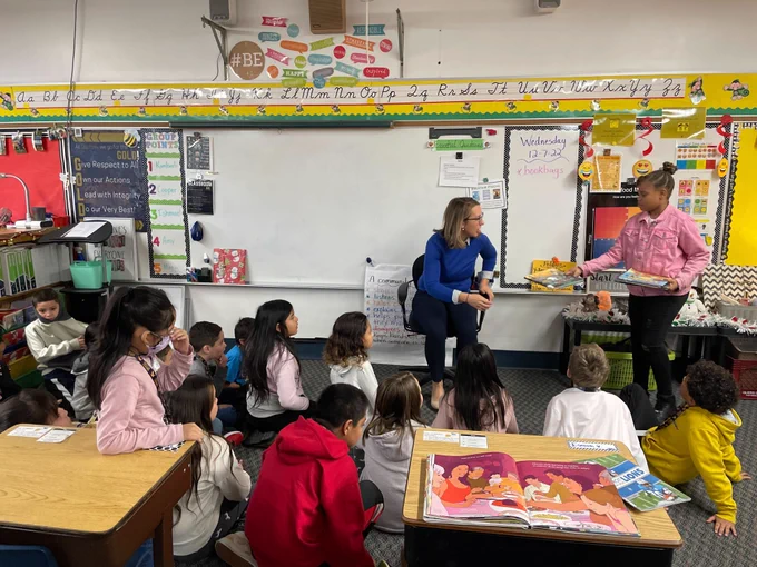 Congresswoman-elect Hillary Scholten is shown at the front of a third-grade classroom in Godfrey-Lee Public Schools, getting ready to read to the students.