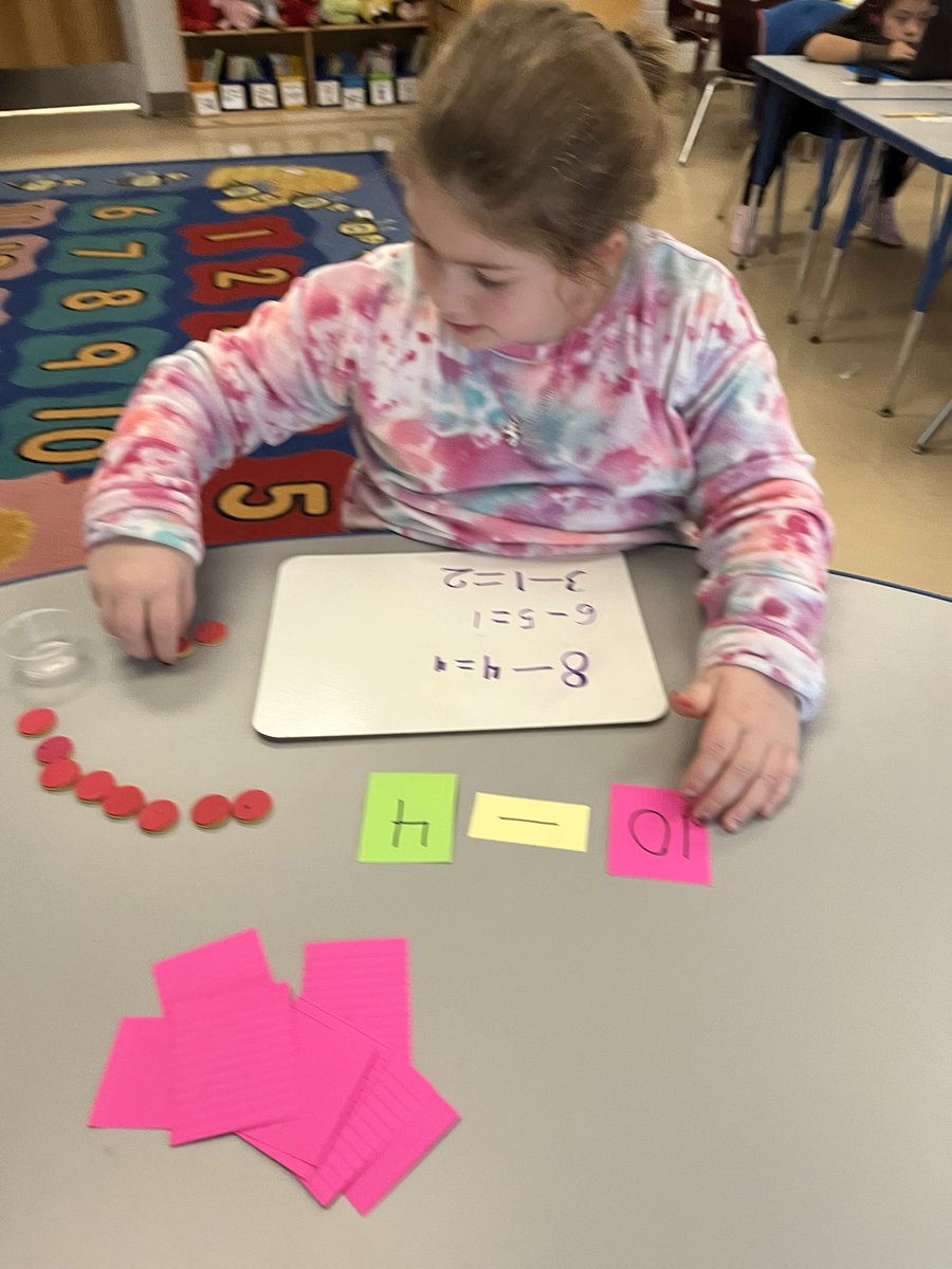1st Graders in Room #6 practiced writing and solving math subtraction equations with counters!