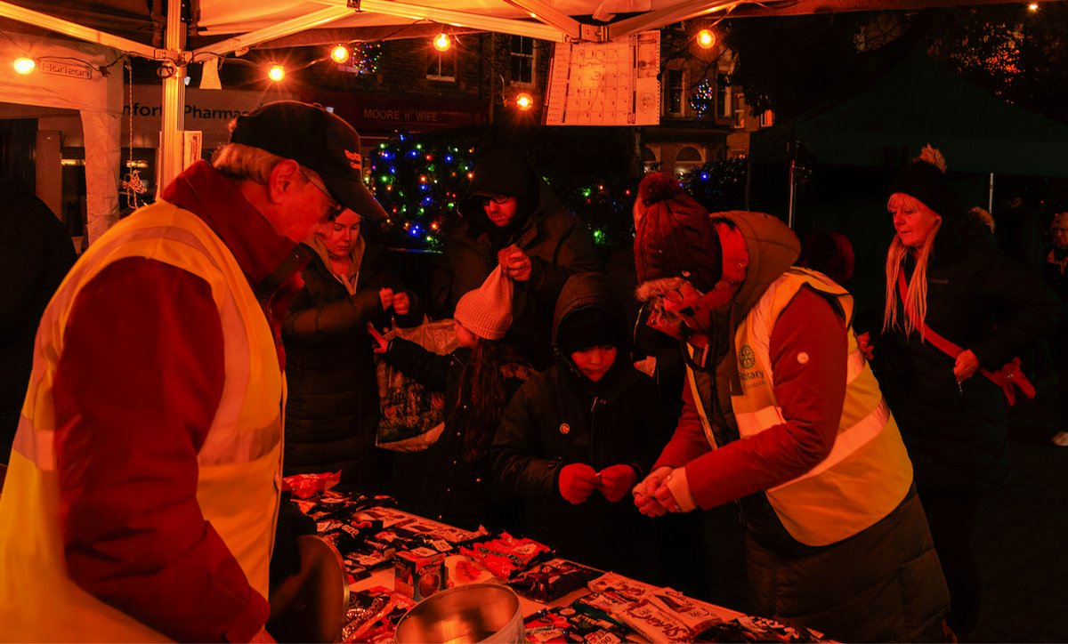 CarnforthRotary's tweet image. Carnforth Rotarians ran the Chocobola stall at the Christmas lights switch on in Market Square. The stall was very colourful  with lots of donated chocolate goodies. It was a very busy evening with everyone being a winner. The prize of course was chocolate in some shape or form.