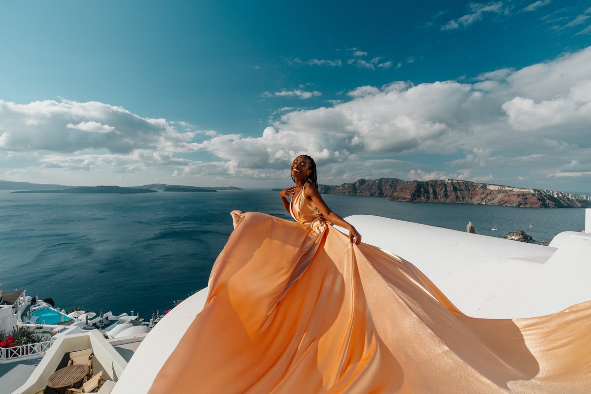 A black woman in a gold dress.