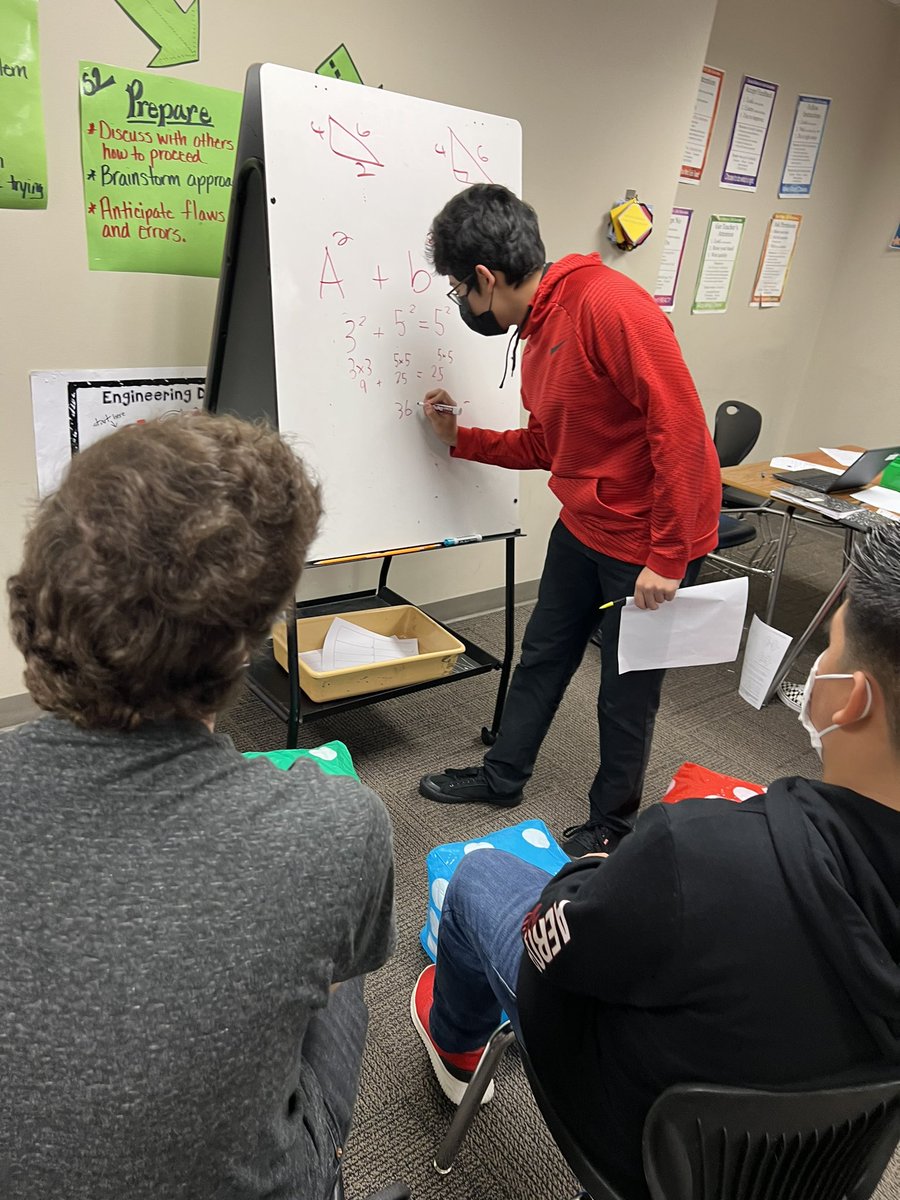 Small group instruction applying #pythagoreantheorem to determine whether three values could be three lengths of a right triangle. #mathrocks