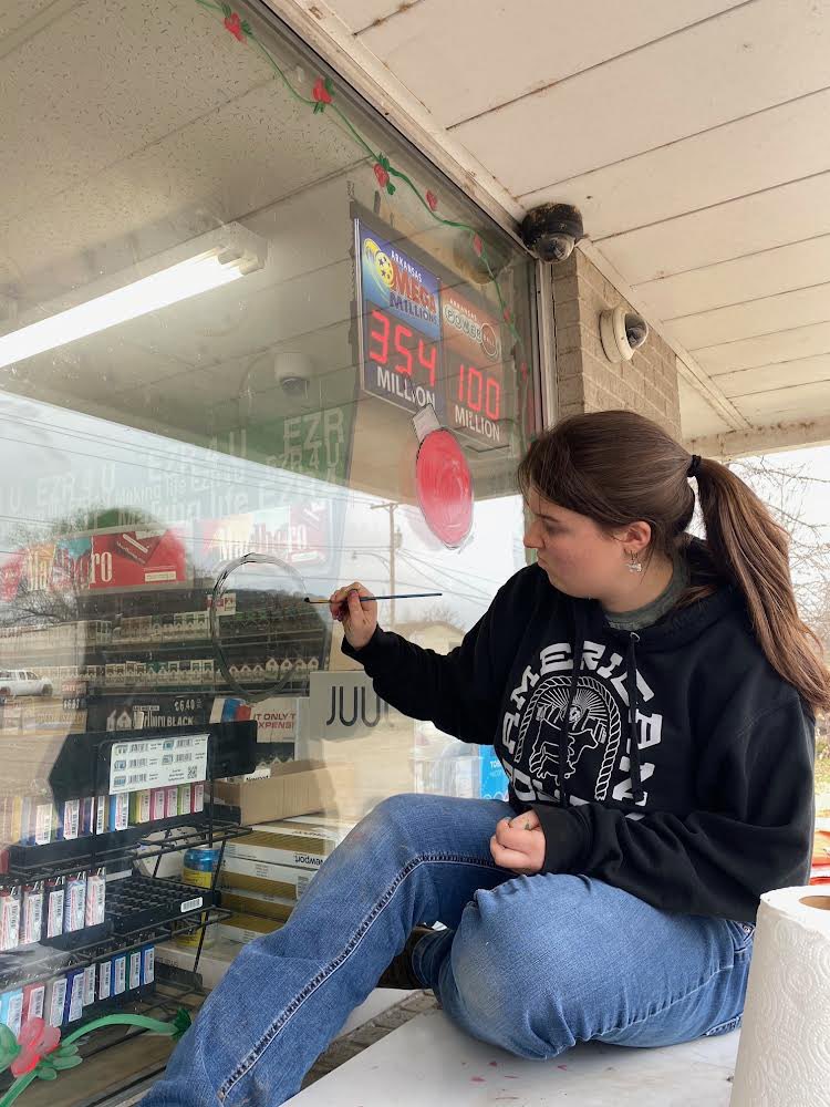 On Tuesday, the Art Club painted holiday greetings on local area businesses!