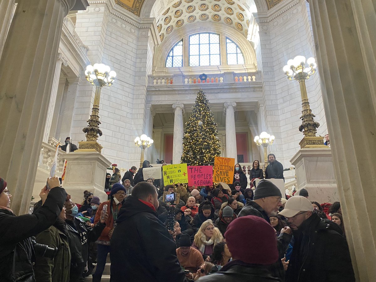 AlexaGagosz's tweet photo. It’s past 9 am. Deadline. 

People in tents are still outside the State House, defying  @GovDanMcKee’s orders to vacate the grounds by 9 today.

Protestors are singing the words “We shall overcome” while sitting inside the State House. 

@Globe_RI https://t.co/nbk45CULXf