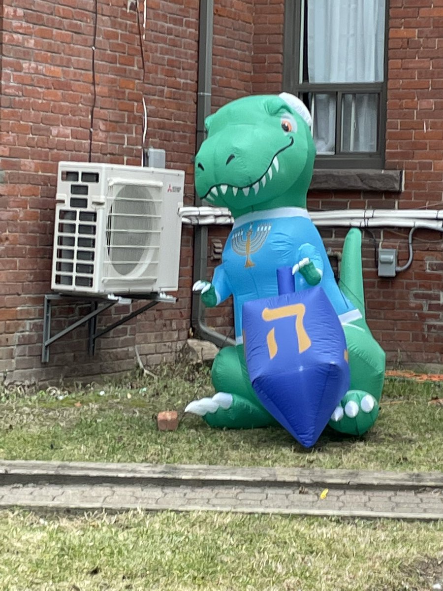 anotherglassbox's tweet photo. Just in terms of man vs beast matchup, inflatable Santa stands no chance against inflatable Hanukkah t-Rex https://t.co/GCmWxlOQKs