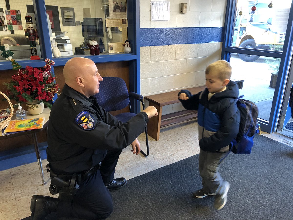 SochaCindy's tweet photo. It was Fist Bump Friday today at the Primary! Staff and students were greeted by our police chief, Nick Miglionico, Officer Brett, two officers and of course Finn! Thank you for the greeting! @DouglasSuper1 @Douglasmapd https://t.co/BbfJoV5Wnc