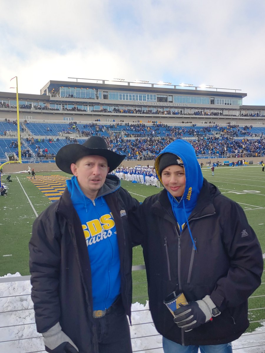 JamesDeanGraham's tweet photo. A little cold, but a lot of pride! We won; 42-21... putting us #1 in FCS with a 12-1 record!
#FatherSonFootball
#GoJacks #Jackrabbits https://t.co/T1vK63WkPN