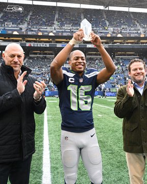 A picture of Tyler Lockett, Chuck Arnold and John Schneider presenting the Walter Payton Man of the Year nomination.