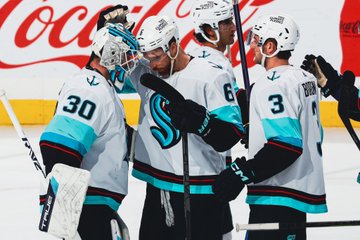 Goalie hugs featuring larsson and Jones