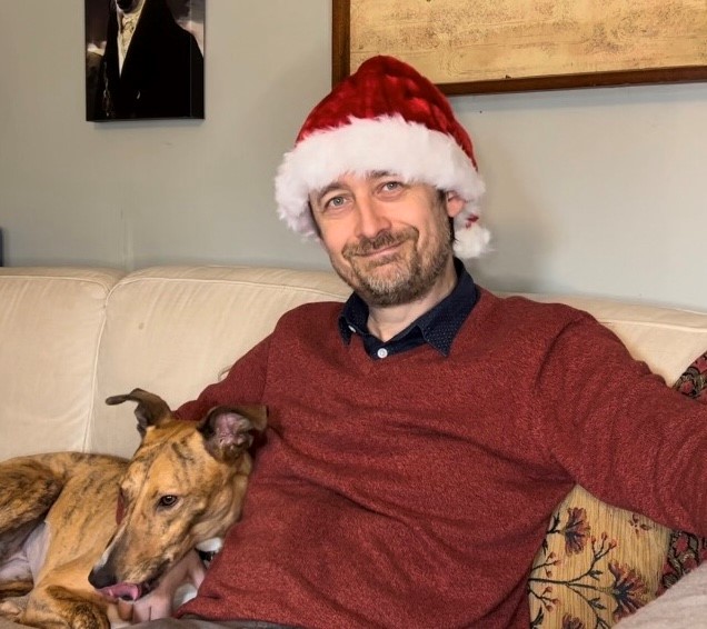 Neil Hannon in his living room with his dog 