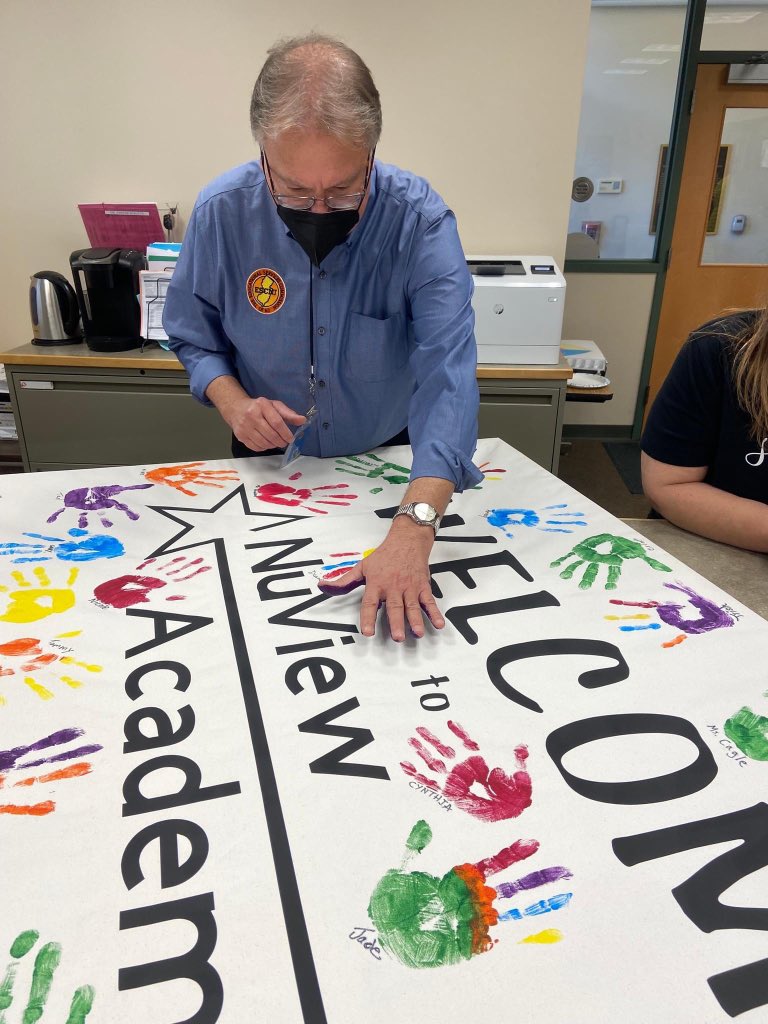ESCofNJ's tweet photo. NuView Academy created a welcome banner 👋 as a team building exercise for the staff members, as well as a creative way to bring some needed color to the entry way! 

Each staff member painted a hand print, to show pride and care for the building and students. #ESCNJ #NuViewNJ https://t.co/nX01YddVmT