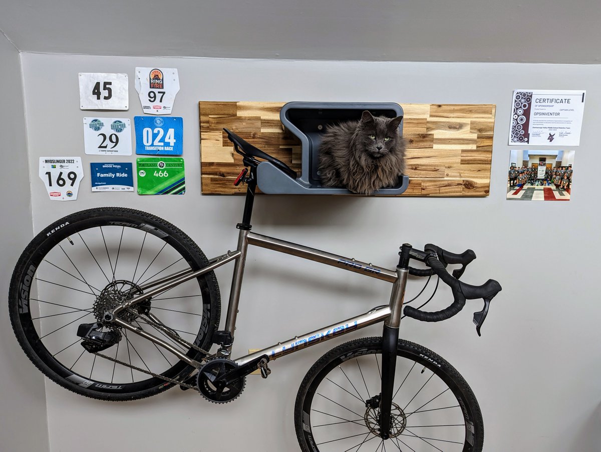 TurboDad's tweet photo. Finished up my @dahanger_ mount for my @LynskeyBikes ProGR behind my desk.  The cat decided that the helmet storage shelf is not for helmets. https://t.co/upARny8mMI