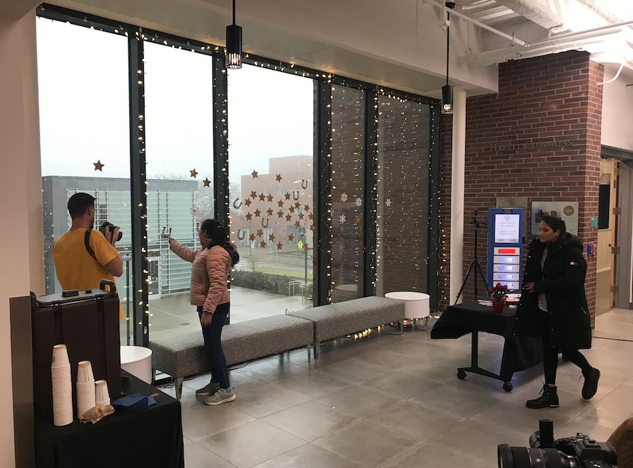 UNewHaven's tweet photo. It's looking festive at #UNewHaven! Graphic designer Laura Norris created a holiday-themed installation in the Bergami Center. Check it out! #HappyHolidays #ChargeHome https://t.co/8z84f7Rom1