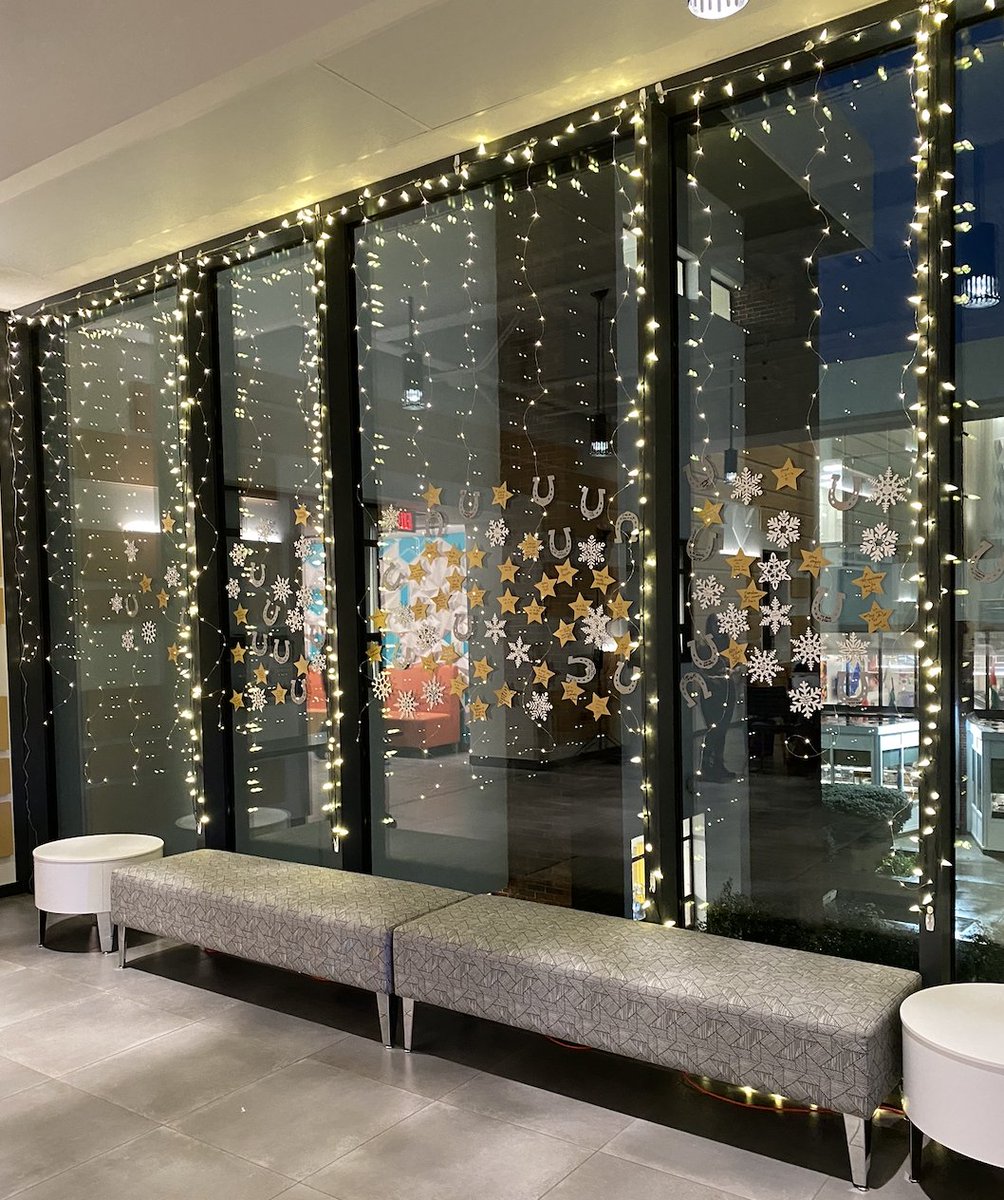 UNewHaven's tweet photo. It's looking festive at #UNewHaven! Graphic designer Laura Norris created a holiday-themed installation in the Bergami Center. Check it out! #HappyHolidays #ChargeHome https://t.co/8z84f7Rom1
