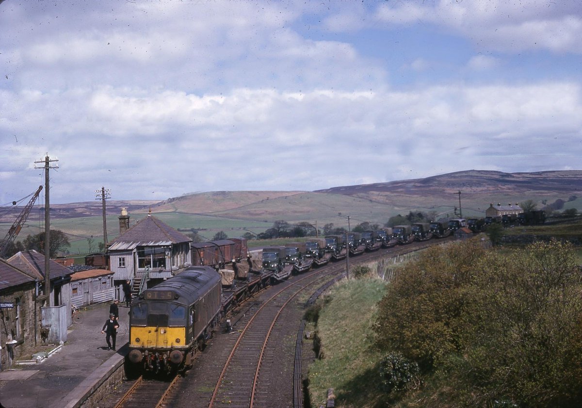 A Class 25 hauls a train of Austin army lorries and 25lb field guns at West Woodburn station, Northumberland c1965 on the Reedsmouth-Scotsgap line, closed to passengers in 1952 and closed for good on October 3 1966. Sorry, don’t know who took the pic