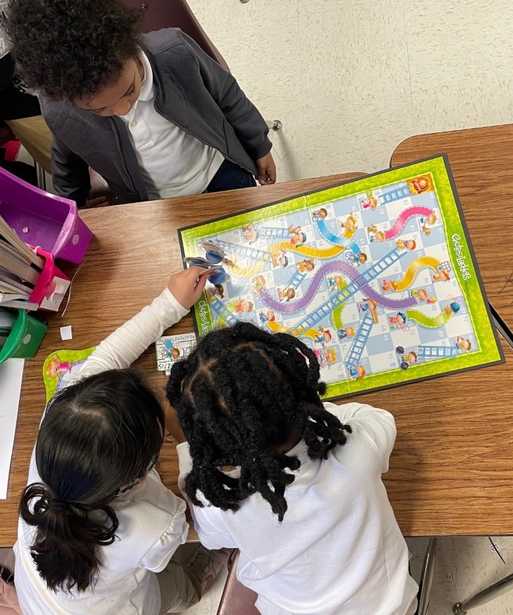 DeeAnnaPier's tweet photo. Oh my!  Can 5 and 6-year-olds have fun learning math with the classic game Shoots and Ladders?  How about tweaking it to teach addition?  The accountable talk between the kids was amazing!  @AnneFrankDISD @dallasschools @JuanCordobaDISD @TeamDallasISD @dallasisdsel @Bmford500 https://t.co/sIgAr7CmJp