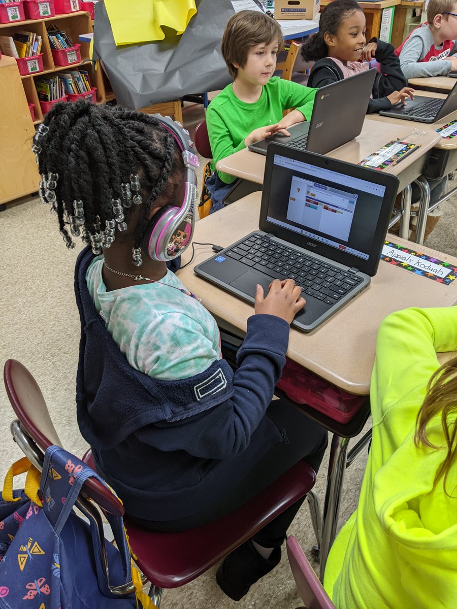 3rd  graders using block code and 5th graders learning to program robots  to perform tasks