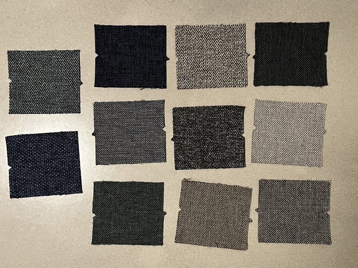 Our couch fabric sample tiles came in. We eliminated a bunch bc they felt too scratchy. Wanted to see what the rest looked like against the floor. Some of these are supposed to be blue or green but apparently everything is actually still grey.