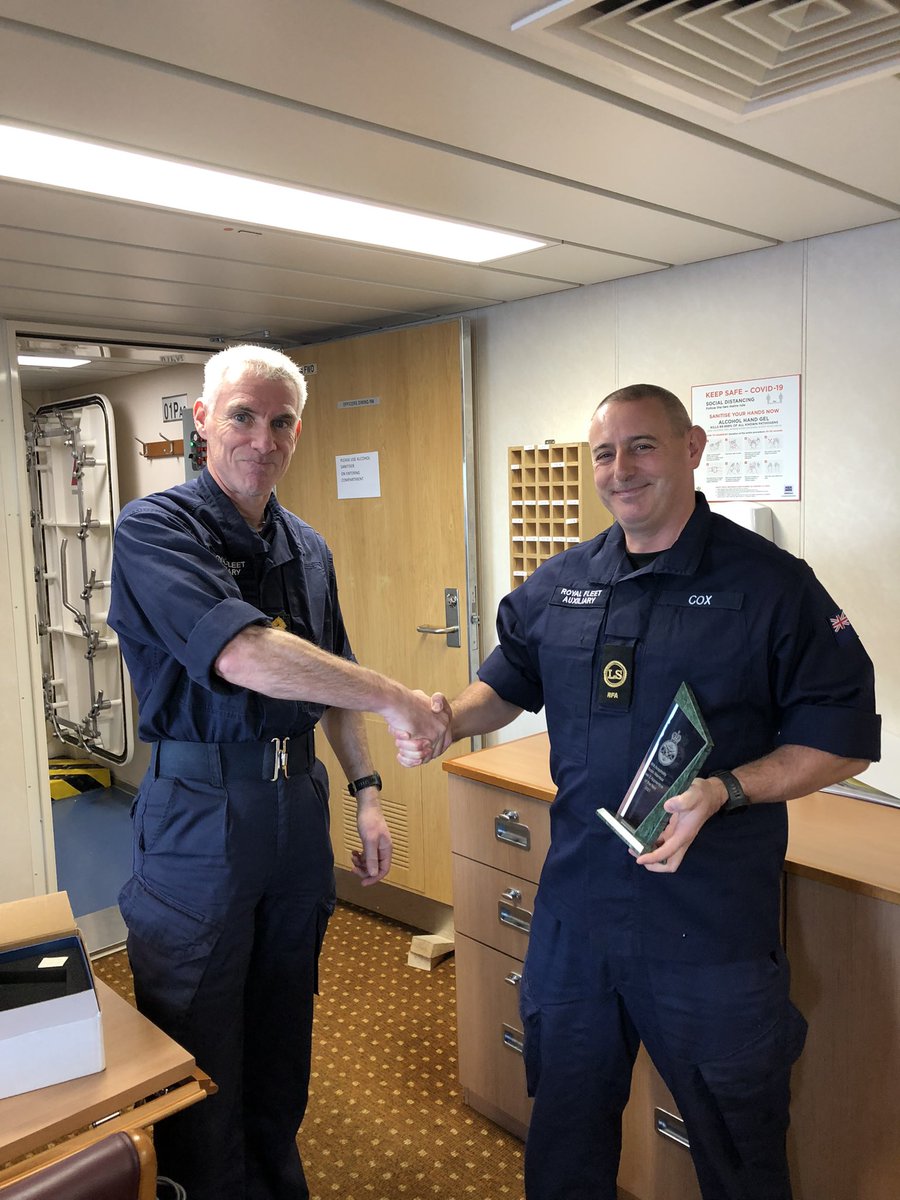 Congratulations and celebrations 👏 Catering & Support Walter John Cox received the Apprentice of Year Award in 2021. Here seen being presented in person by Captain Vernoum. The question is: Where will you display it? @RFAHeadquarters