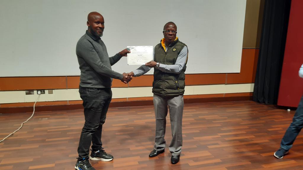 Our Ceo Maina Migwi receiving a certificate from the Chair of Mediation Accreditation Committee Justice Odunga at the 'Mediating Banking Disputes Workshop' at Lake Naivasha Resort