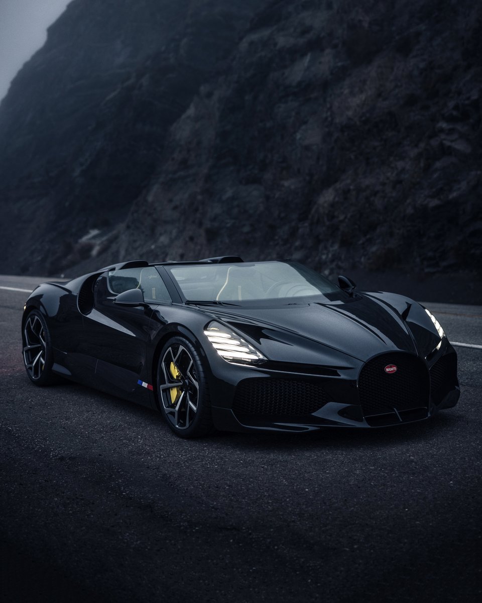 Bugatti's tweet photo. In the early morning light at Point Mugu, California, the W16 MISTRAL stands out with its signature four-bar motif headlights – a nod to its quad turbochargers and four-wheel-drive – and X-shaped rear light design, inspired by the BOLIDE.  

#BUGATTI
–
https://t.co/mCEE0ghyaw https://t.co/wkHX2Igc67