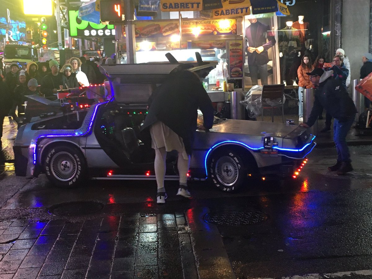 Aster_dexmint's tweet photo. Back to Future Delorean broken down in Times Square with Doc Brown pushing it to the side. Sad end to a DMC12 @MotorWeek https://t.co/2TyfDTsYqO