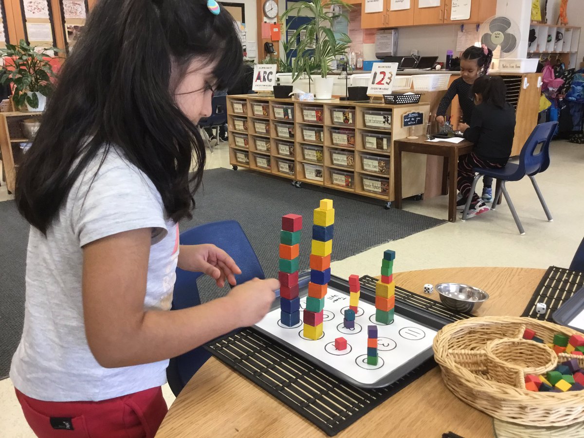 KingswoodKinder's tweet photo. While playing the ‘Tower Up’ math game, Ss are subitizing quantities on the dice, identifying numerals, using 1:1 correspondence and representing numbers using wooden blocks. https://t.co/32HwG12S8Q