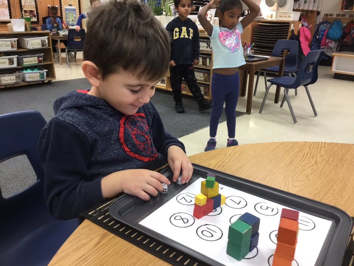 KingswoodKinder's tweet photo. While playing the ‘Tower Up’ math game, Ss are subitizing quantities on the dice, identifying numerals, using 1:1 correspondence and representing numbers using wooden blocks. https://t.co/32HwG12S8Q