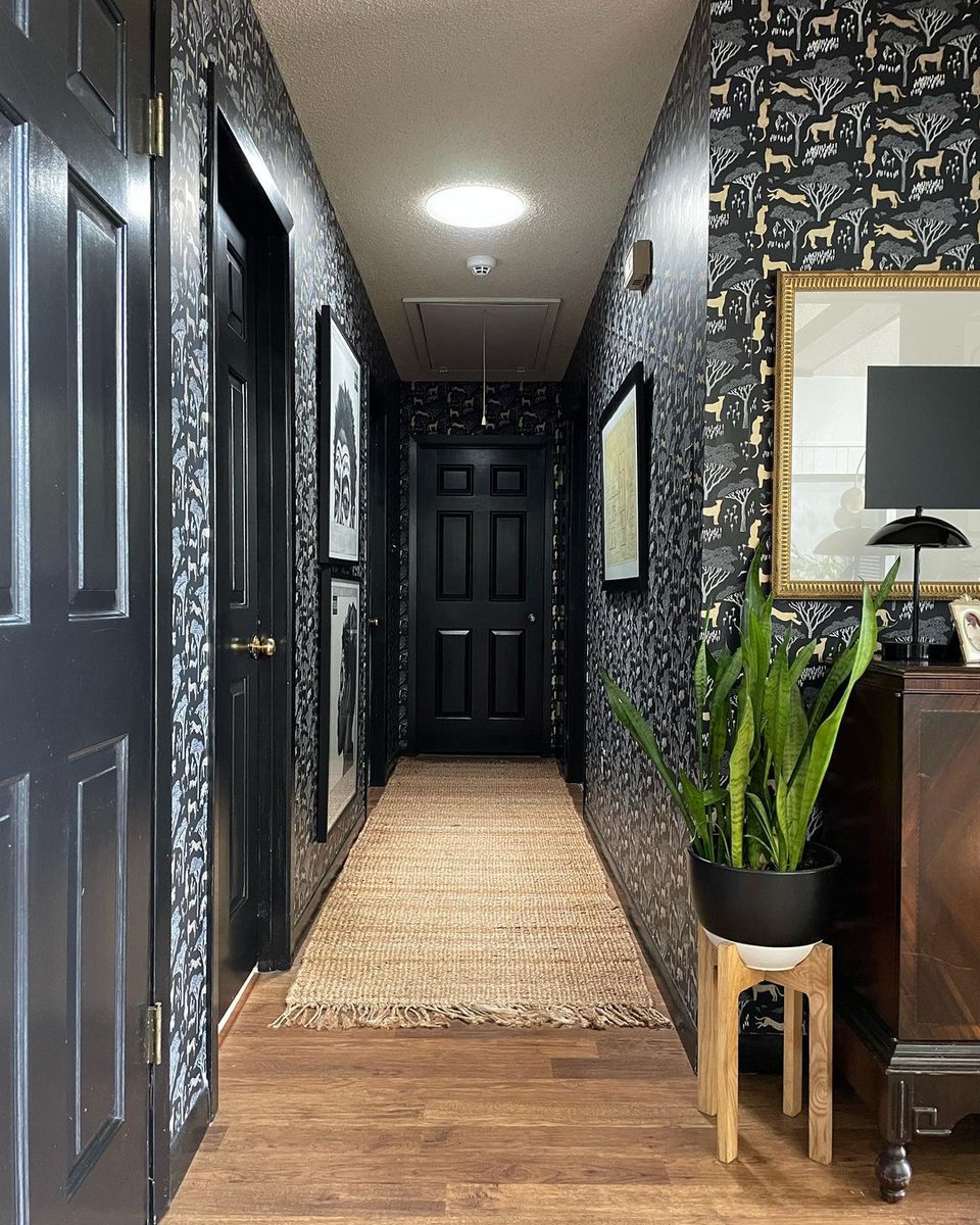 #Designtrends to watch: moody wallpaper. This #SunTunnelSunday, we're featuring @carmeonhamilton's head-turning hallway.  We love how she balanced the dark color palette with light wooden floors and natural light from a #SunTunnel #Skylight.