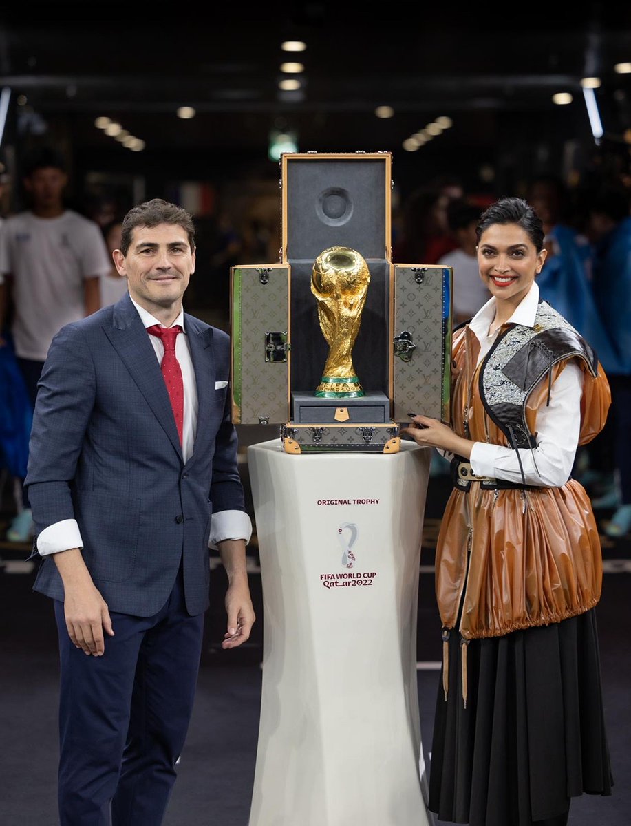 LouisVuitton's tweet photo. Victory Travels in Louis Vuitton. #DeepikaPadukone and #IkerCasillas presented the ultimate prize in football in a bespoke #LouisVuitton trophy trunk at the #FIFAWorldCup2022 Final. Learn more about the Maison’s custom travel cases at https://t.co/JfKdULAlfo https://t.co/IraTCkkzNY