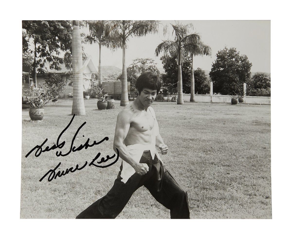 Sold for 11,520. A black and white photograph signed by Bruce Lee