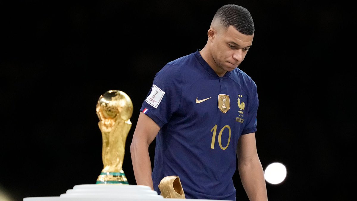 usetvgof's tweet photo. Kylian Mbappe walks past the World Cup trophy following France's loss https://t.co/97ai9oAExn