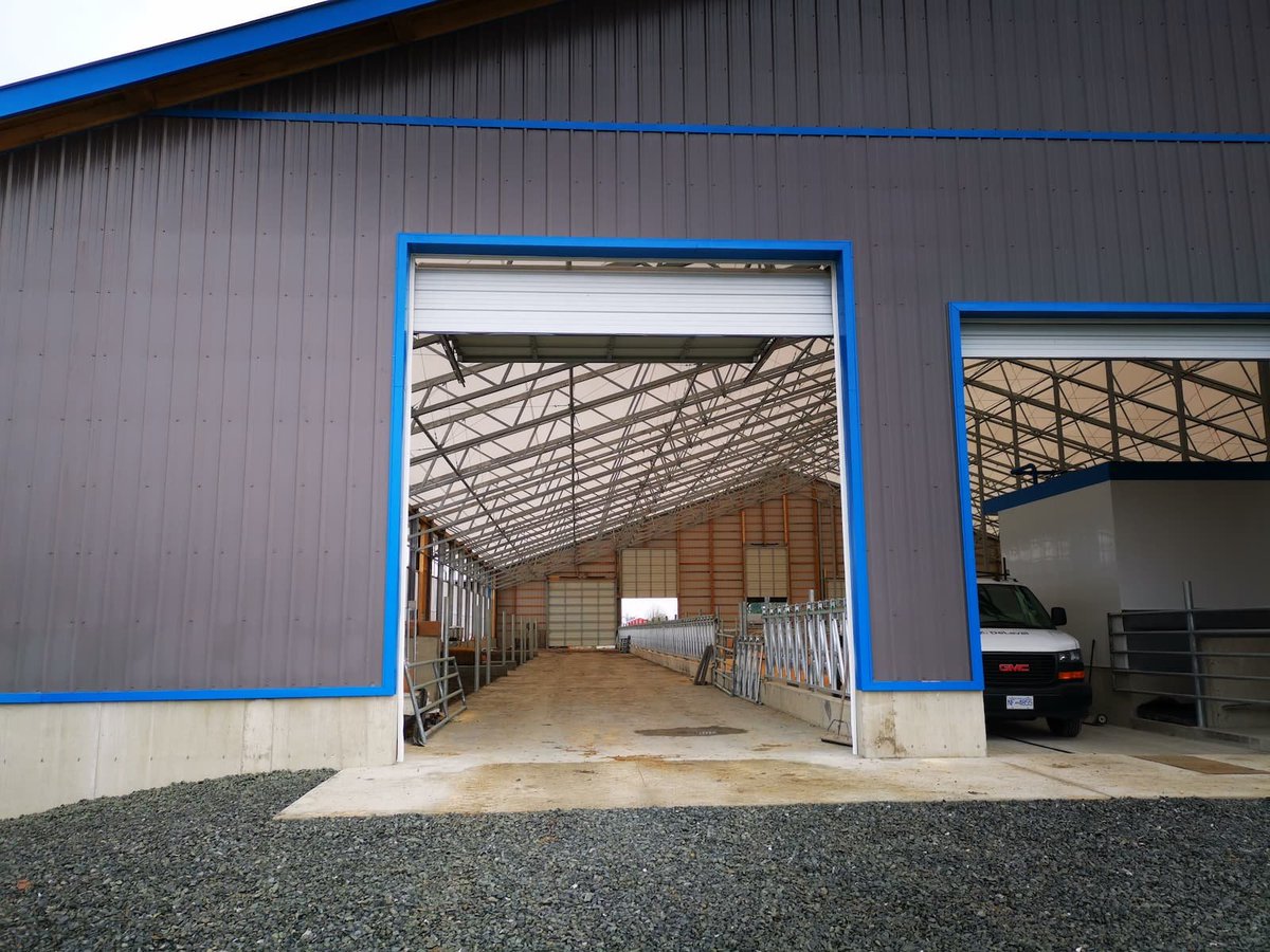 WeCover_Steel's tweet photo. Located in Pitt Meadows, BC, this airy, light-filled, and well ventilated fabric roof barn has everything needed for these dairy cows. For better production and the health of your herd, go with #WeCover. https://t.co/lJtJaG3qob