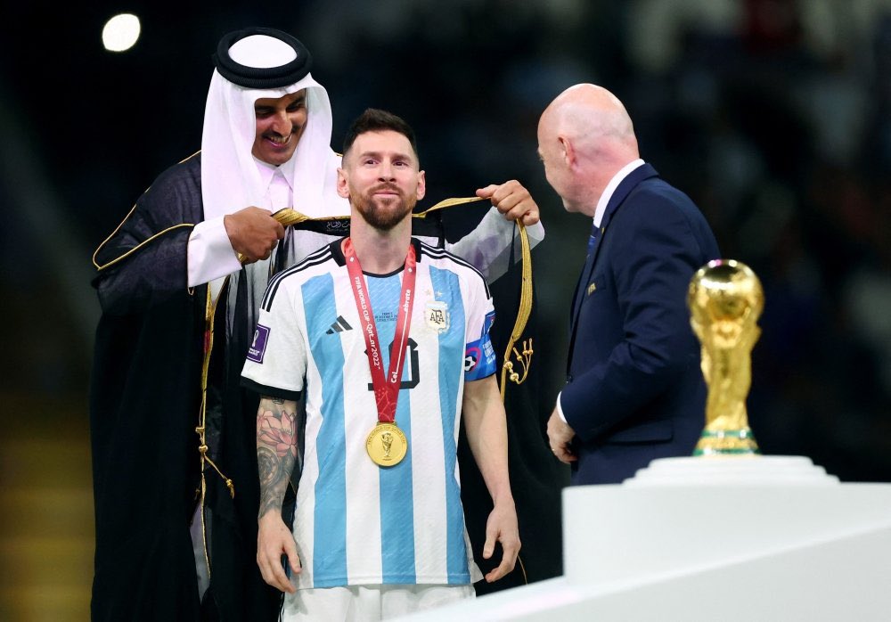 KhaledBeydoun's tweet photo. Placing a bisht around somebody is a great display of honor. It’s intended for royalty, and Messi was crowned World Cup champion. 

Think: British monarchy honoring somebody with knighthood. 

But, western media pundits only see Qatar and Islam through eyes of ignorance. https://t.co/kMfmCWBJMS