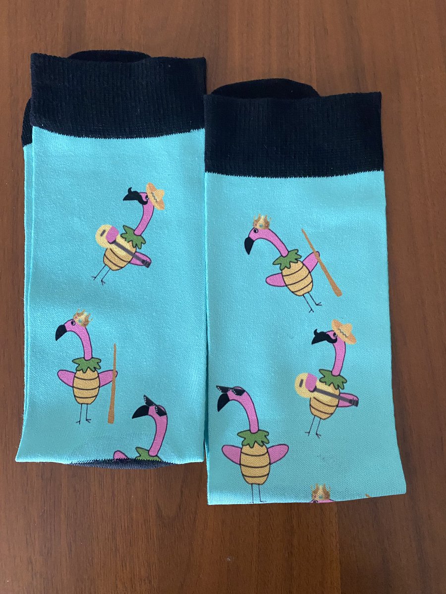LauraFreeze's tweet photo. @SFBayFerry After ordering some ferry branded socks 2+ weeks ago, the package finally arrived with flamingos instead of ferries? I know they’re festive, but not quite what I expected! 😅 So I join other commenters I’ve seen asking you to rethink the company you contract with. https://t.co/xw5FzM0gKz