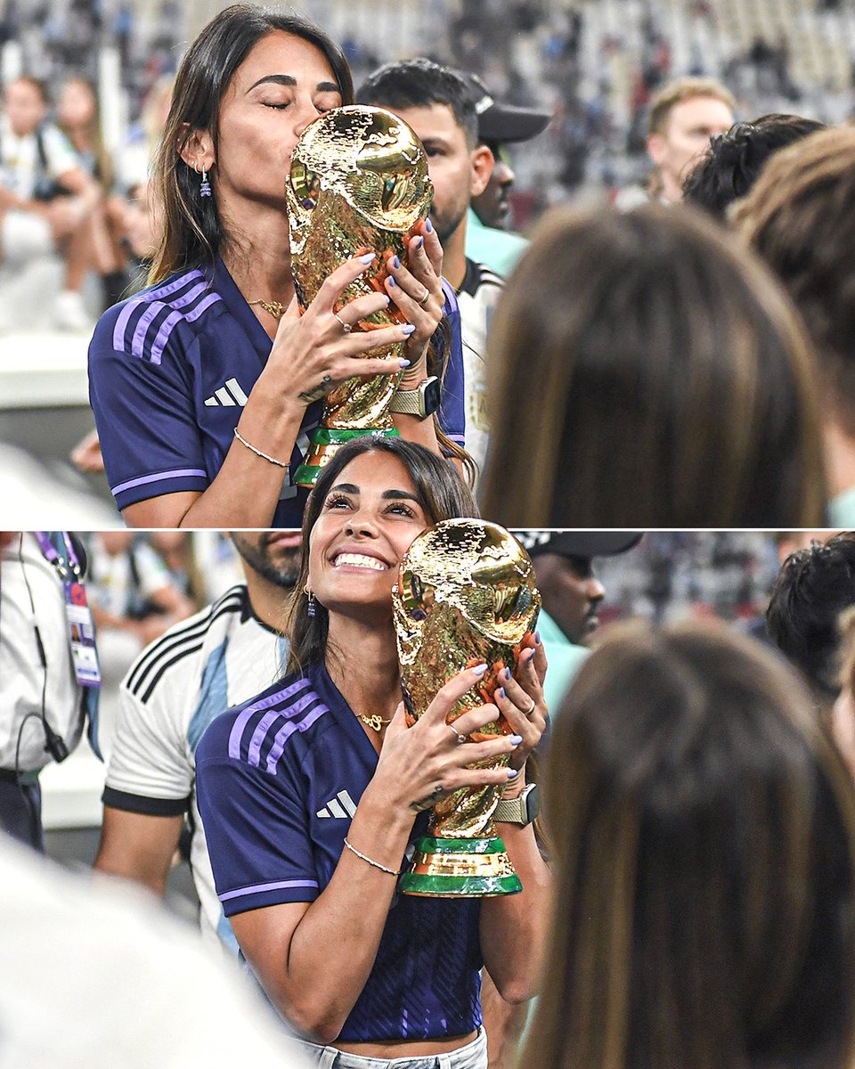 Antonela Roccuzzo, Lionel Messi's wife, celebrating with the World Cup trophy 🇦🇷💙