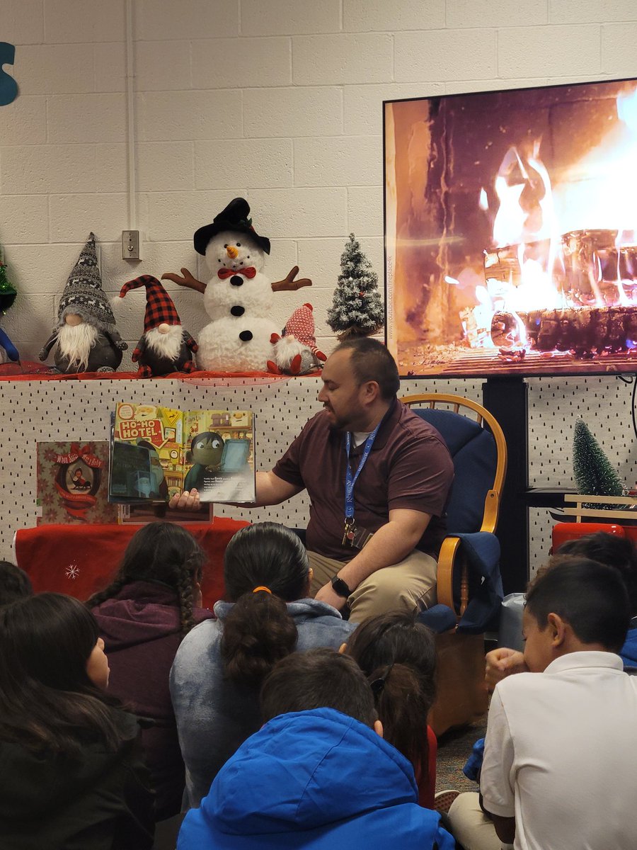 MrsPlascensia's tweet photo. Nurse Brown and Mr Zepeda joined us in the library for a book by the "fireplace"! @LivelyEagles #LivelyReads #WinterReadAloud https://t.co/AkPREy3KVF