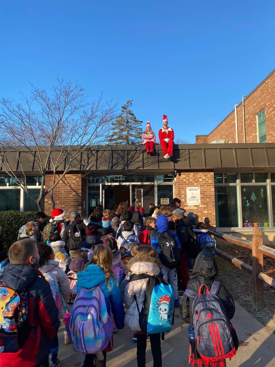 Principal Elves on the Shelf! Spreading holiday cheer at arrival! Love seeing all the children smile as they enter the building!