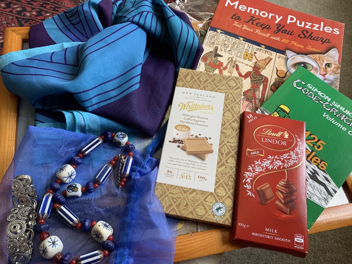 LynnetteRoss11's tweet photo. Oh my goodness . . . how lucky am I? Jewellery, a beautiful matching blue Scarf, two Puzzle books, and chocolate x2 to nibble on while trying to keep my ageing brain challenged. Thank you so much to my Secret Santa. #SecretSantaNZ2022 https://t.co/uQjt240bx2