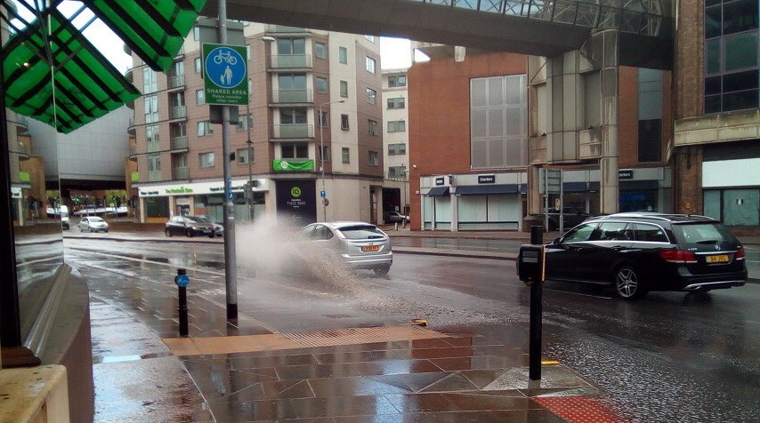 KingstonCycling's tweet photo. Since @RBKingston hasn't responded to our requests to unblock the drains on Wood Street alongside Bentalls, we've emailed a ward Councillor in the hope they can work some magic. The pavement and cycle track get drenched from the #ponding rainwater every time it rains. https://t.co/PgfwwjsXR1