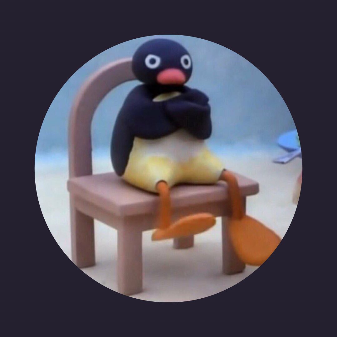 A circular image of an angry claymation penguin in a chair on a square grayish blue background